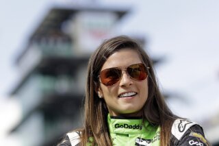 FILE - In this May 20, 2018, file photo, Danica Patrick waits during qualifications for the IndyCar Indianapolis 500 auto race at Indianapolis Motor Speedway in Indianapolis. Patrick, who retired from racing after last year's Indianapolis 500, will join NBC Sports' inaugural coverage of the Indianapolis 500 as a studio analyst alongside host Mike Tirico. (AP Photo/Darron Cummings, File)