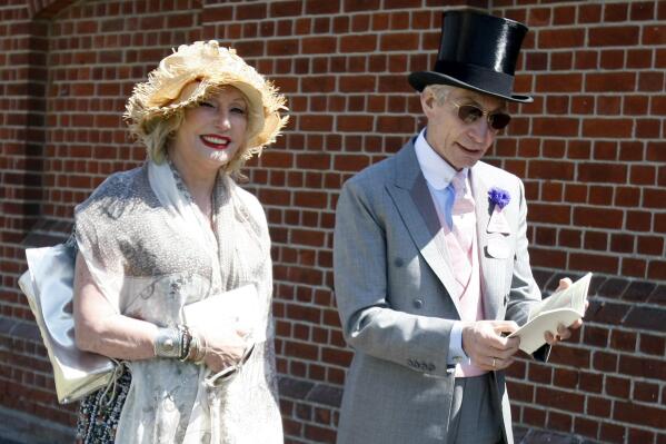 FILE - Charlie Watts, the drummer of the Rolling Stones, with his wife Shirley, arrive on the third day of the Royal Ascot horse racing meeting at Ascot, England, Thursday, June, 17, 2010. Shirley Ann Watts, a former art student and prominent breeder of Arabian horses who met drummer Charlie Watts well before he joined the Rolling Stones and with him formed one of rock's most enduring marriages, has died at age 84. "Shirley died peacefully on Friday 16th December in Devon after a short illness surrounded by her family," her family announced Monday, Dec. 19, 2022. (AP Photo/Alastair Grant, File)