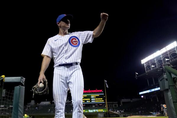 Chicago Cubs relief pitcher Hayden Wesneski gestures to the crowd as he leaves the field with the game ball during his Major League debut, in the team's 9-3 win over the Cincinnati Reds a baseball game Tuesday, Sept. 6, 2022, in Chicago. (AP Photo/Charles Rex Arbogast)