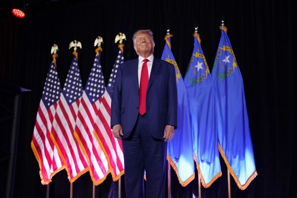 FILE - Former President Donald Trump stands on stage before speaking at a campaign event, July 8, 2023, in Las Vegas. Trump's push to bend state Republican parties to his will, and gain an advantage in his effort to return to the White House, is coming to a head in Nevada. (AP Photo/John Locher, File)