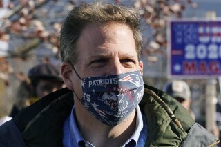 FILE - In this Nov. 3, 2020 file photograph, N.H. Gov. Chris Sununu wears a protective mask, due to the COVID-19 virus outbreak, at a polling station in Windham, N.H. New Hampshire joined three doz...