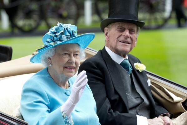 FILE - In this file photo dated Thursday, June, 19, 2014, Britain's Queen Elizabeth II, and Prince Philip arrive by carriage in the parade ring on the third day of the Royal Ascot horse racing meeting, at Ascot, England.  In the TV program ‘Prince Philip: The Royal Family Remembers’ released late Saturday Sept. 18, 2021, members of the royal family have spoken admiringly of the late Duke of Edinburgh’s barbecuing skills. (AP Photo/Alastair Grant, FILE)
