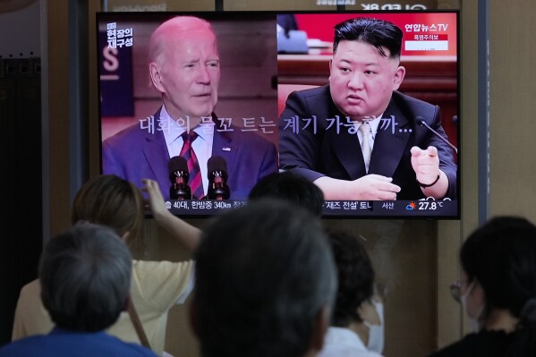 FILE - A TV screen shows file images of U.S. President Joe Biden, left, and North Korean leader Kim Jong Un during a news program reporting on American soldier Travis King, at the Seoul Railway Station in Seoul, South Korea, Saturday, July 22, 2023. The Biden administration is extending for another year a ban on the use of U.S. passports for travel to North Korea, the State Department said Tuesday, Aug. 22. The ban was imposed in 2017 and has been renewed every year since. (AP Photo/Ahn Young-joon, File)