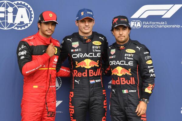 Red Bull driver Max Verstappen of the Netherlands, center, clocking the fastest time, poses with Ferrari driver Carlos Sainz of Spain, left, clocking the second fastest time and Red Bull driver Sergio Perez of Mexico, clocking the third fastest time in the qualifying session ahead of the Formula One Grand Prix at the Spa-Francorchamps racetrack in Spa, Belgium, Saturday, Aug. 27, 2022. The Belgian Formula One Grand Prix will take place on Sunday. (AP Photo/Geert Vanden Wijngaert, Pool)