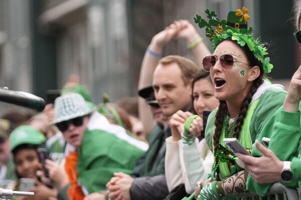Spectators cheer during the St. Patrick's Day parade, Sunday, March 16, 2025, in Boston, Mass. (AP Photo/Robert F. Bukaty)