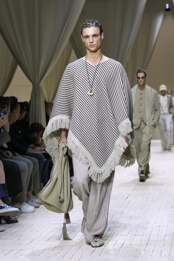 A model wears a creation as part of the men's Emporio Armani Spring-Summer 2026 collection, that was presented in Milan, Italy, Saturday, June 21, 2025. (AP Photo/Luca Bruno)