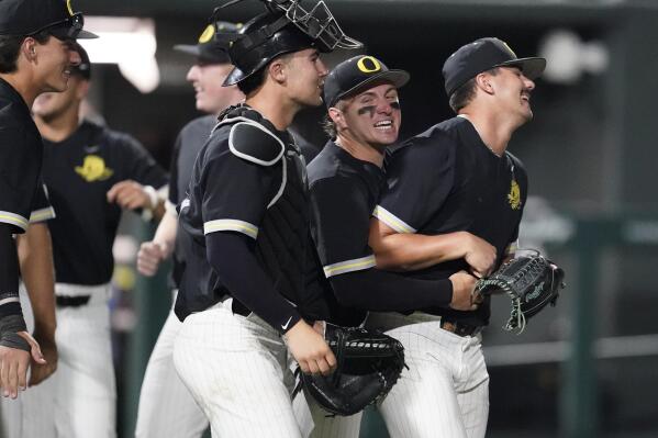 Oregon pitcher Logan Mercado, right, is congratulated by teammates after the team's 11-2 win against Xavier following an NCAA college baseball tournament regional championship game Sunday, June 4, 2023, in Nashville, Tenn. (AP Photo/George Walker IV)