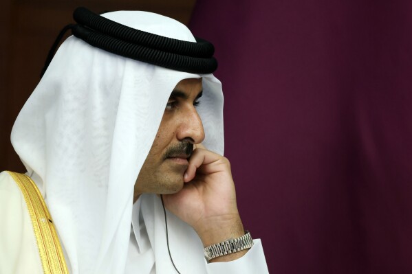 FILE - The Emir of Qatar, Sheikh Tamim bin Hamad Al Thani reacts during a meeting, in Astana, Kazakhstan, Thursday, Oct. 13, 2022. Sheikh Tamim bin Hamad Al Thani, channeled the wider anger in the Arab world over Israel's unrelenting airstrikes and siege of the Gaza Strip that the Hamas-controlled Health Ministry says has killed over 5,000 people so far. (Vyacheslav Prokofyev, Sputnik, Kremlin Pool Photo via AP, File)