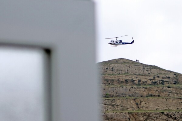 In this photo provided by Islamic Republic News Agency, IRNA, the helicopter carrying Iranian President Ebrahim Raisi takes off at the Iranian border with Azerbaijan after President Raisi and his Azeri counterpart Ilham Aliyev inaugurated the dam of Qiz Qalasi, or Castel of Girl in Azeri, Iran, Sunday, May 19, 2024. A helicopter carrying President Raisi suffered a "hard landing" on Sunday, Iranian state media reported, without elaborating. (Ali Hamed Haghdoust/IRNA via AP)