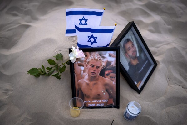 FILE - A photo of Keshet Casarotti, 21, who was killed in Hamas' militants rampage through Nova Music Festival in southern Israel on Oct. 7, is displayed at a vigil on the beach honoring the victims in Tel Aviv, Israel, Saturday, Nov. 11, 2023. (AP Photo/Oded Balilty, File)