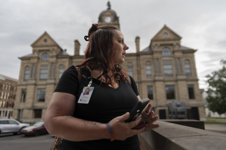 Jesse Johnson of the Family Resource Center waits for a client at Hancock County Probate/Juvenile Court in Findlay, Ohio, Thursday, Oct. 12, 2023. (AP Photo/Carolyn Kaster)