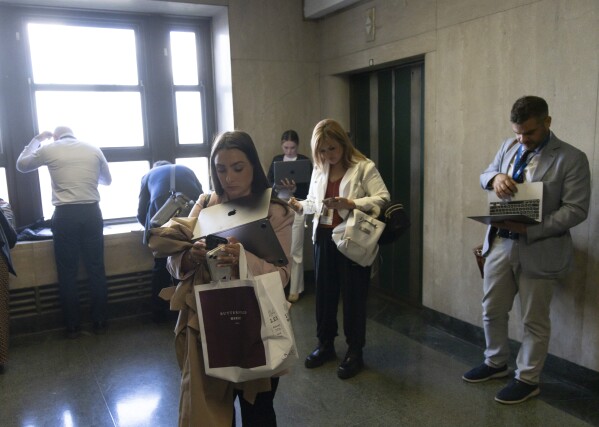 Journalists filing stories in a hallway after a jury found former President Donald Trump guilty on all 34 counts in his criminal trial at Manhattan Criminal Court, Thursday, May 30, 2024, in New York. (Justin Lane/Pool Photo via AP)