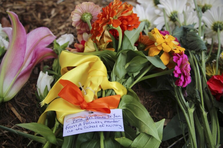 Flowers are seen piled up in front of Caudill Labs, Tuesday, Aug. 29, 2023 on the UNC-Chapel Hill campus, where a graduate student fatally shot his faculty advisor, Zijie Yan, this week in Chapel Hill, N.C. (AP Photo/Hannah Schoenbaum)