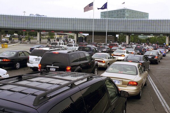 FILE - In this Aug. 4, 2005, file photo, traffic traveling from Niagara Falls, Ontario, Canada, lines up on the Rainbow Bridge to enter the United States through a border checkpoint at Niagara Falls, N.Y. The Department of Homeland Security said on Thursday, June 23, 2020, that New Yorkers would once again be allowed to enroll and re-enroll in Global Entry and other federal travel programs that allow vetted travelers to avoid long security lines at the U.S. border. (AP Photo/Don Heupel, File)