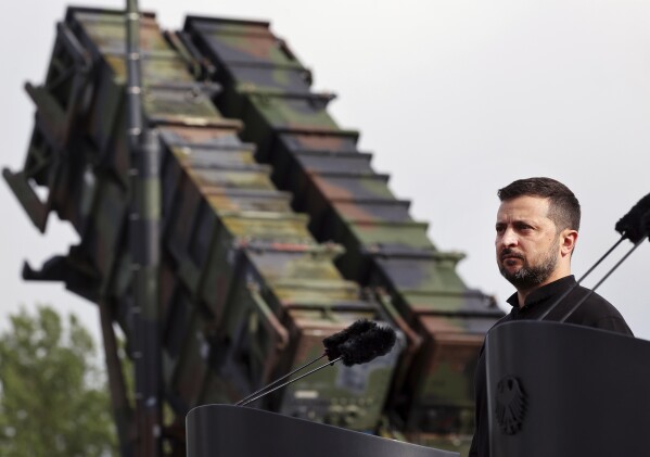 Ukraine's President Volodymyr Zelenskyy stands in front of a Patriot air defense missile system during a visit to a military training area in the German state of Western Pomerania, Tuesday, June 11, 20242, to learn about the training of Ukrainian soldiers on the "Patriot" air defence missile system. (Jens Buettner/dpa via AP)
