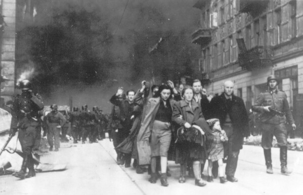In this 1943 file photo, a group of Polish Jews are led away for deportation by German SS soldiers during the destruction of the Warsaw Ghetto by German troops after an uprising in the Jewish quarter ghetto by German soldiers on April 19, 1943. (AP Photo)