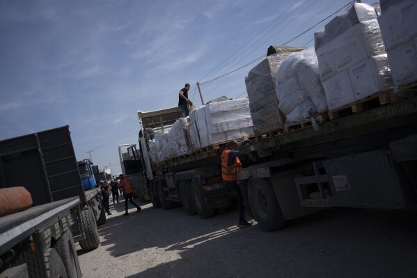 Trucks with humanitarian aid for the 'Gaza Strip enter from Egypt in Rafah on Saturday, Oct. 21, 2023. (AP Photo/Fatima Shbair)