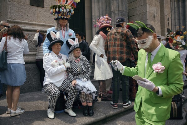 Revelers wearing decorated hats and costumes participate in the annual Easter Parade and Bonnet Festival in front of St. Patrick's Cathedral on Sunday, April 20, 2025, in New York. (AP Photo/Andres Kudacki)