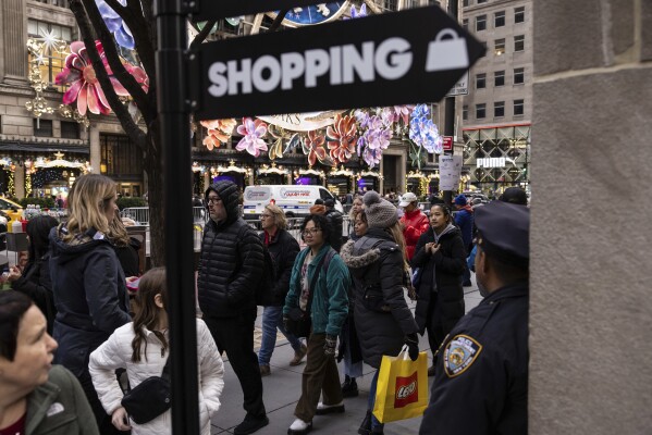 Shoppers and sightseers walk on the 5th Avenue, Monday, Dec. 11, 2023, in New York. On Thursday, the Commerce Department releases U.S. retail sales data for November. (AP Photo/Yuki Iwamura)