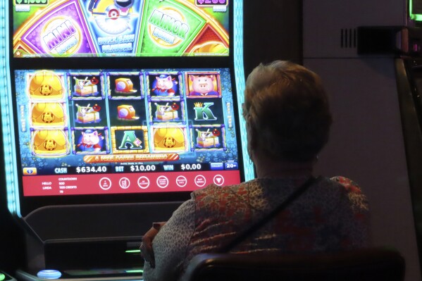 A gambler plays a slot machine at Harrah's casino in Atlantic City N.J. on Sept. 29, 2023. Figures released on Friday, Feb. 16, 2024, from state gambling regulators show the total amount won by Atlantic City's nine casinos, the three horse tracks that take sports bets, and their online partners was more than $559 million in January, up 28% from a year earlier. But much of that was powered by a record-setting month of internet gambling ($183 million, up nearly 20% from a year ago) and sports betting (nearly $171 million, up more than 136%). (AP Photo/Wayne Parry)
