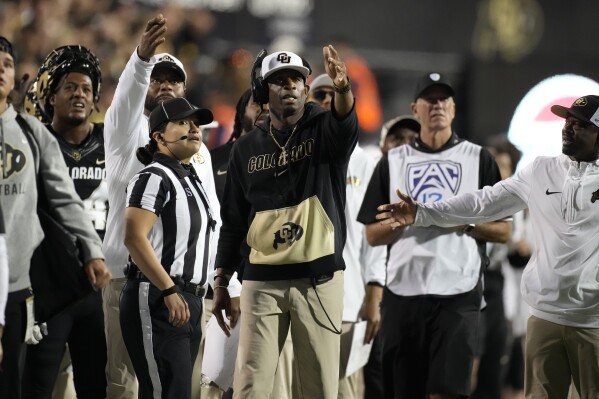 Colorado head coach Deion Sanders, center, complains about a call in the second half of an NCAA college football game against Colorado State Saturday, Sept. 16, 2023, in Boulder, Colo. (AP Photo/David Zalubowski)