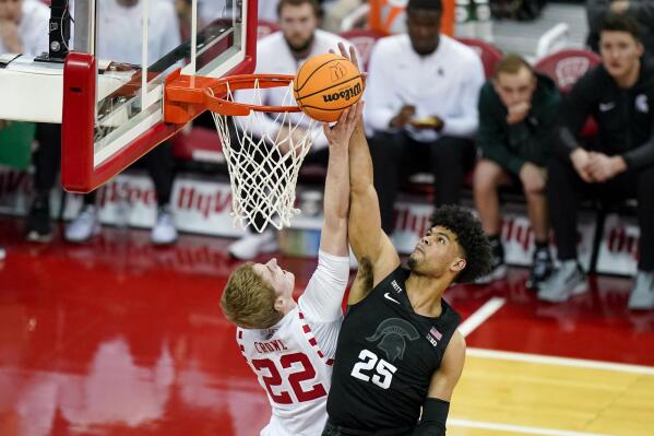 Michigan State's Malik Hall (25) blocks a shot by Wisconsin's Steven Crowl (22) during the first half of an NCAA college basketball game Friday, Jan. 21, 2022, in Madison, Wis. (AP Photo/Andy Manis)