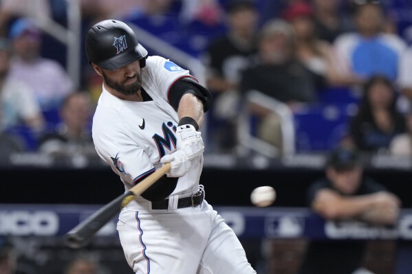 Miami Marlins' Jon Berti hits a double scoring Nick Fortes during the third inning of a baseball game against the Houston Astros, Monday, Aug. 14, 2023, in Miami. (AP Photo/Wilfredo Lee)