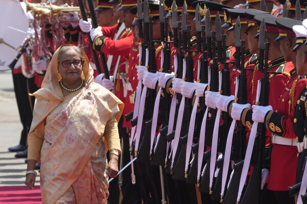 Bangladesh's Prime Minister Sheikh Hasina reviews an honor guard during a welcome ceremony at the government house in Bangkok, Thailand, Friday, April 26, 2024. (AP Photo/Sakchai Lalit, File)