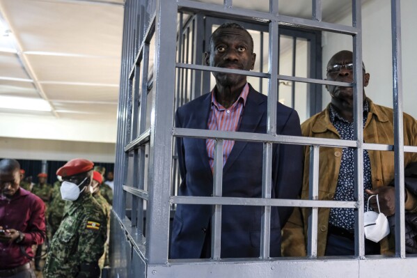 Ugandan opposition leader and four-time presidential candidate Kizza Besigye, stands in the dock at the Makindye Martial Court in Kampala, Uganda Wednesday, Nov. 20. 2024. (AP Photo/Hajarah Nalwadda, File)