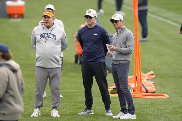 Denver Broncos head coach Sean Payton, left, general manager George Paton, center, and part-owner and chief executive officer Greg Penner look on as players take part in drills during the NFL football team's rookie minicamp, Saturday, May 13, 2023, in Centennial, Colo. (AP Photo/David Zalubowski)