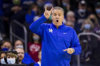 Kentucky head coach John Calipari signals to players during an NCAA college basketball game against Notre Dame on Saturday, Dec. 11, 2021, in South Bend, Ind. (AP Photo/Robert Franklin)