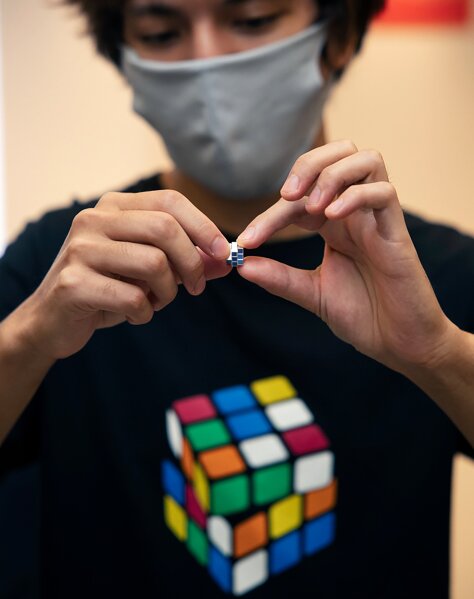 In this photo provided by Maciej Komorowski of Hungary Embassy, the world's smallest Rubik's Cube is shown in Tokyo Wednesday, Sept. 23, 2020, to commemorate the 40th anniversary of the six-sided puzzle in Japan. A tiny but playable Rubik’s Cube, so little it fits on your fingertip, has gone on sale in Japan for 198,000 yen, or about $1,900, for delivery starting in December. (Maciej Komorowski of Hungary Embassy via AP)