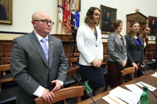 
              FILE - In this Feb. 27, 2019, file photo, from left, transgender military members Navy Lt. Cmdr. Blake Dremann, Army Capt. Alivia Stehlik, Army Capt. Jennifer Peace, Army Staff Sgt. Patricia King and Navy Petty Officer Third Class Akira Wyatt, listen before the start of a House Armed Services Subcommittee on Military Personnel hearing on Capitol Hill in Washington. The Defense Department has approved a new policy that will largely bar transgender troops and military recruits from transitioning to another sex, and require most individuals to serve in their birth gender. (AP Photo/Manuel Balce Ceneta, File)
            