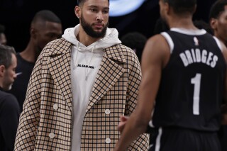Brooklyn Nets guard Ben Simmons greets Mikal Bridges (1) walking to the bench against the Miami Heat during the first half of an NBA basketball game, Saturday, Nov. 25, 2023, in New York. (AP Photo/Adam Hunger)