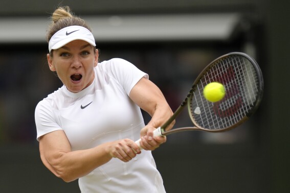 FILE - Romania's Simona Halep returns to Amanda Anisimova of the US in a women's singles quarterfinal match at the Wimbledon tennis championships in London, Wednesday, July 6, 2022. Former Wimbledon and French Open champion Simona Halep has a three-day appeal hearing in February to challenge her four-year ban for doping. The Court of Arbitration for Sport says on Tuesday, Dec. 12, 2023 it set Feb. 7-9 for Halep’s appeal against the International Tennis Integrity Agency. (AP Photo/Kirsty Wigglesworth, file)