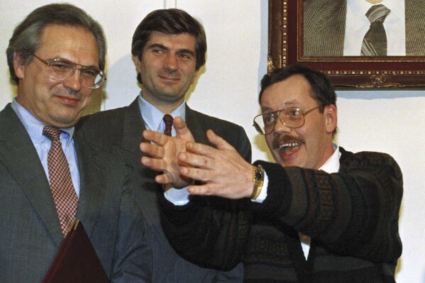 FILE - United Nations mediator Giandomenico Picco, center, accompanies Terry Anderson, chief Middle East correspondent for the Associated Press, during a news conference at the Syrian Foreign Ministry in Damascus, Dec. 4, 1991. At left is American Ambassador Christopher Ross. Picco, whose negotiating skills helped resolve some of the thorniest crises of the 1980s and 1990s, including the Iran-Iraq war and the kidnappings of Westerners by Hezbollah in Lebanon, died Sunday, March 10, 2024. (AP Photo/Mohammad Ali, file)