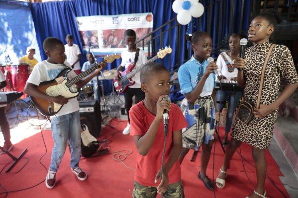 Music students practice at the Plezi Mizik Composition Futures School in Port-au-Prince, Haiti, Saturday, Sept. 23, 2023. Students in the program are allowed to choose any instrument. Available are guitars, keyboards, bass guitars, maracas, ukeleles, tambourines and cowbells. (AP Photo/Odelyn Joseph)