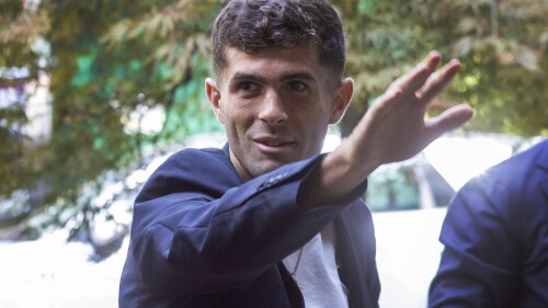 United States soccer player Christian Pulisic waves as he arrives in Milan, Italy, Wednesday, July 12, 2023, for medical tests at Italian Serie A soccer team AC Milan before an expected transfer from British club FC Chelsea. (Stefano Porta/LaPresse via AP)