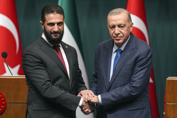 Turkish President Recep Tayyip Erdogan, right, shakes hands with Syria's interim President Ahmad al-Sharaa during a joint press conference following their meeting at the presidential palace in Ankara, Turkey, Feb. 4, 2025. (AP Photo/Francisco Seco, File)