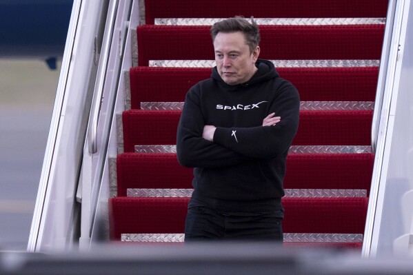 Elon Musk arrives on Air Force One at Philadelphia International Airport, Saturday, March 22, 2025, in Philadelphia. (AP Photo/Chris Szagola)