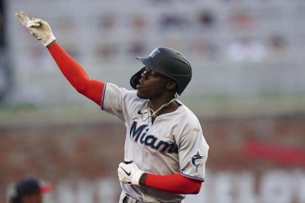 Miami Marlins' Jazz Chisholm Jr. gestures as he runs the bases after hitting a solo home run during the first inning of the team's baseball game against the Atlanta Braves on Saturday, April 23, 2022, in Atlanta. (AP Photo/John Bazemore)