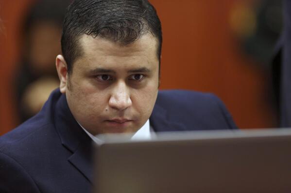George Zimmerman looks at information on a laptop during jury selection in his trial in Seminole circuit court in Sanford, Fla., June 20, 2013. A judge in Florida has dismissed a defamation and conspiracy lawsuit former neighborhood watch volunteer George Zimmerman had filed against the parents of Trayvon Martin, the teen he fatally shot almost a decade ago in a case that drew international attention about race and gun violence. (Gary Green/Orlando Sentinel via AP, Pool)