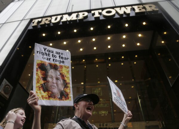 
              FILE- In this Oct. 4, 2018 file photo, protesters rally in front of Trump Tower in New York. Many believed that the presidency would be a boon to Donald Trump's business, but signs are emerging that it has hurt it instead. "He can be very polarizing ... the brand has been diminished," said Jeff Lotman, CEO of licensing firm Global Icons. New York brand consultant Robert Passikoff put it more bluntly: "The Trump brand has lost its mojo." (AP Photo/Seth Wenig, File)
            
