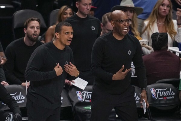 Boston Celtics head coach Joe Mazzulla, left, and assistant coach Sam Cassell react during the first half in Game 3 of the NBA basketball finals against the Dallas Mavericks, Wednesday, June 12, 2024, in Dallas. (AP Photo/Tony Gutierrez)