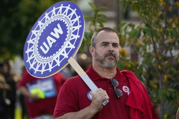 United Auto Workers member John Weyer walks in the Labor Day parade in Detroit, Monday, Sept. 4, 2023. (AP Photo/Paul Sancya)