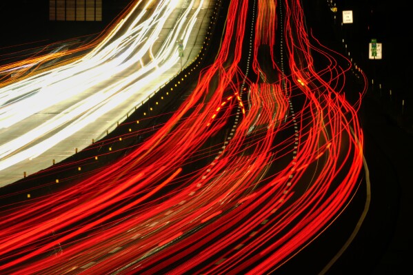 In this long exposure photo, motor vehicles move along Interstate 276 in Feasterville, Pa., Thursday, Dec. 21, 2023. (AP Photo/Matt Rourke)