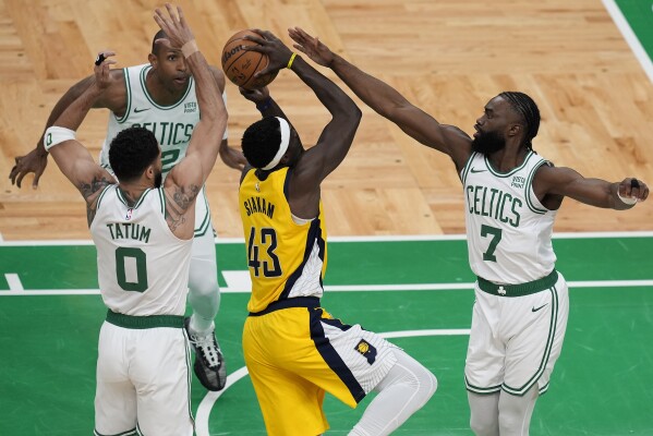 Indiana Pacers forward Pascal Siakam (43) goes up for a shot against Boston Celtics guard Jaylen Brown (7), forward Jayson Tatum (0) and center Al Horford (42) during the first quarter of Game 1 of the NBA Eastern Conference basketball finals, Tuesday, May 21, 2024, in Boston. (AP Photo/Michael Dwyer)
