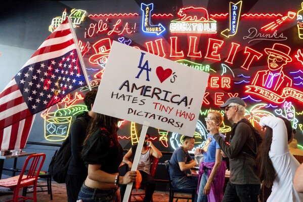 Demonstrators walks through Grand Central Market during a protest Saturday, June 14, 2025, in Los Angeles. (AP Photo/Noah Berger)