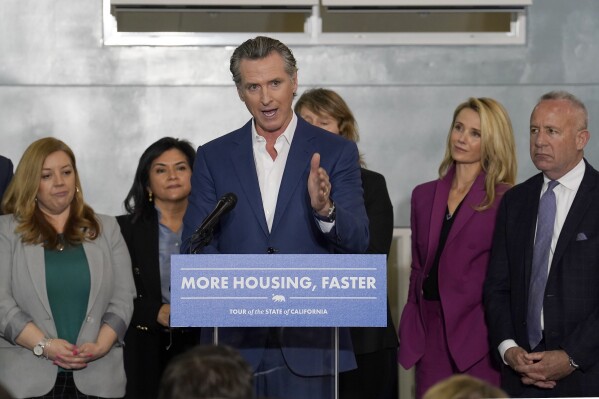 FILE - California Gov. Gavin Newsom announces a proposal to build 1,200 small homes across the state to reduce homelessness in Sacramento Calif., on March 16, 2023. Newsom signed two laws on Wednesday, Oct. 11, 2023, to fast-track low-income housing on surplus land owned by nonprofit colleges and religious institutions and to streamline the housing permitting process. (AP Photo/Rich Pedroncelli, File)