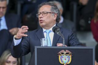 Colombian President Gustavo Petro speaks during the swearing-in ceremony for Gen. William Salamana as the new police chief in Bogota, Colombia, Tuesday, May 9, 2023. (AP Photo/John Vizcaino)